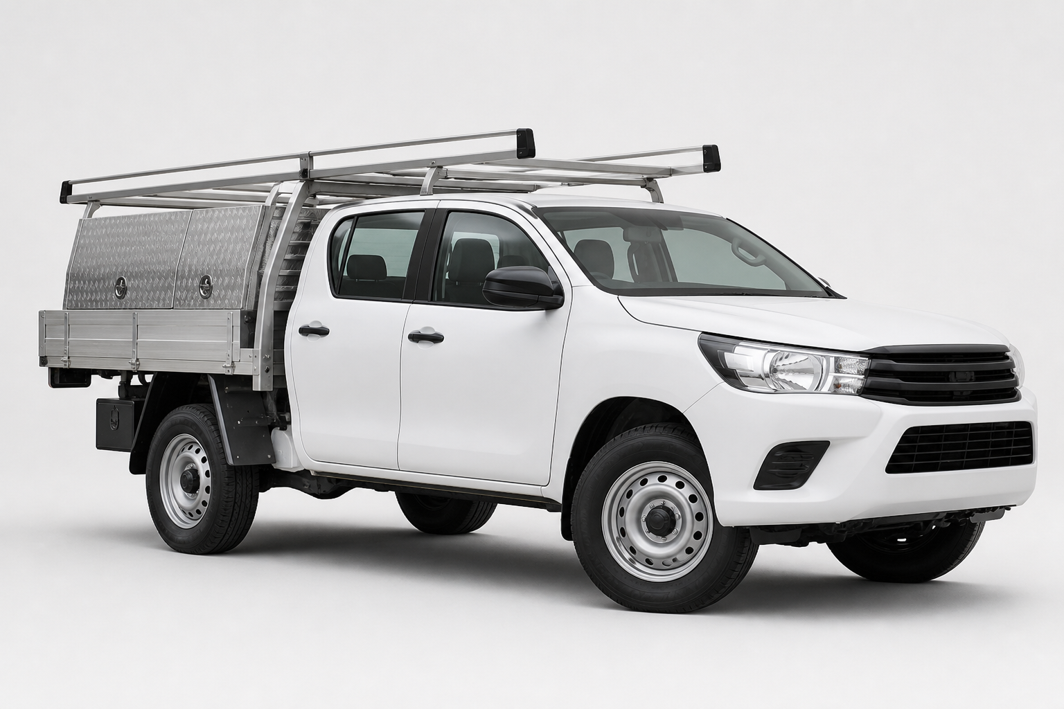 White dual-cab trade ute fitted with aluminium tray, toolboxes and ladder rack